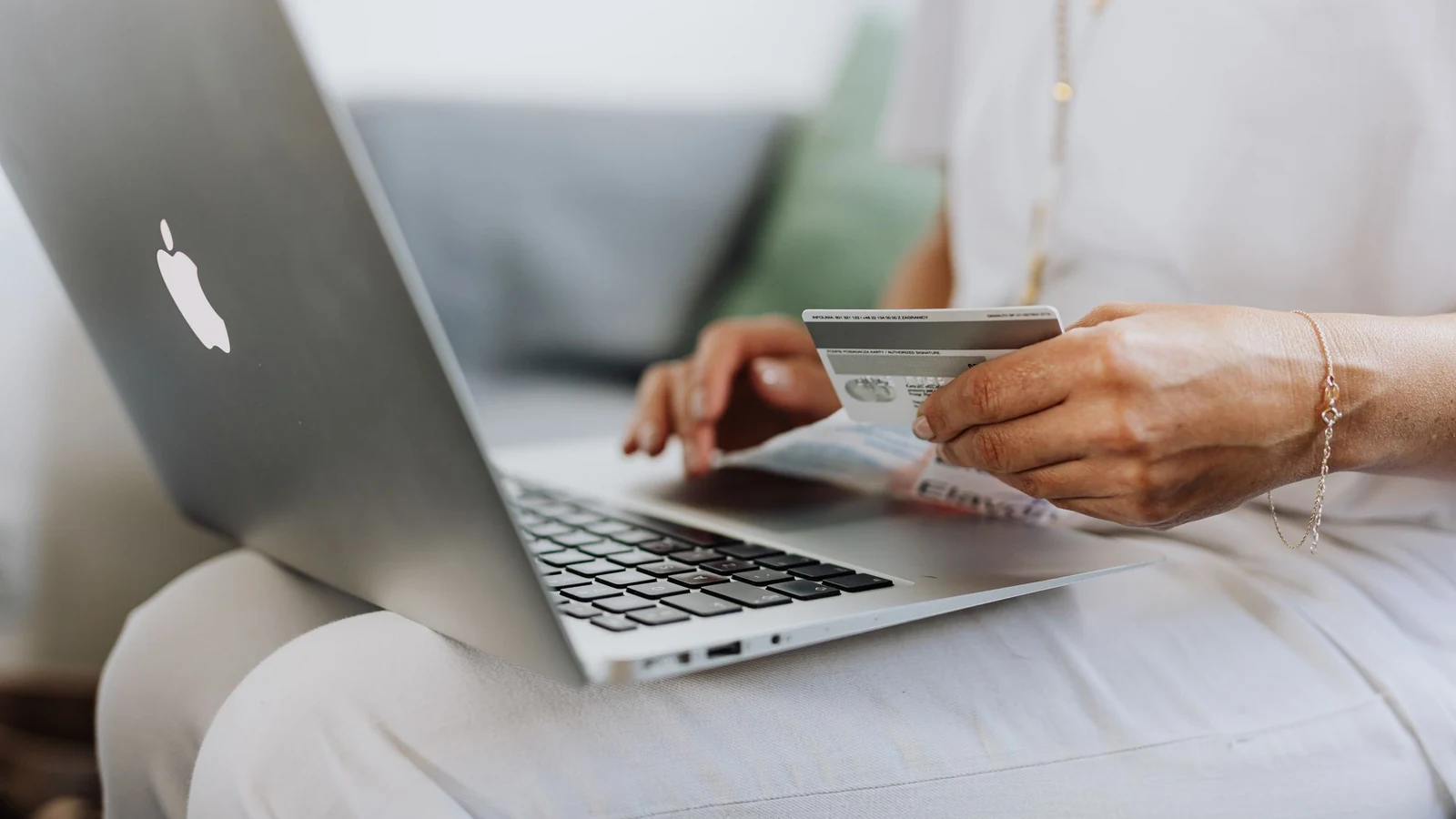 Booking flights on a laptop with a card — airline site versus comparison