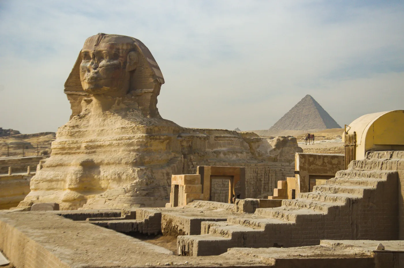 Great Sphinx and Giza pyramids at golden hour