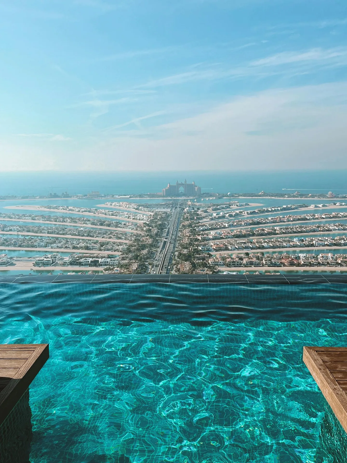 Palm Jumeirah infinity pool — Palm Jumeirah vs Marina stay comparison