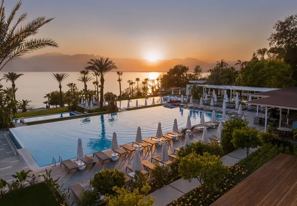 Akra Antalya — sunset pool deck overlooking the Mediterranean