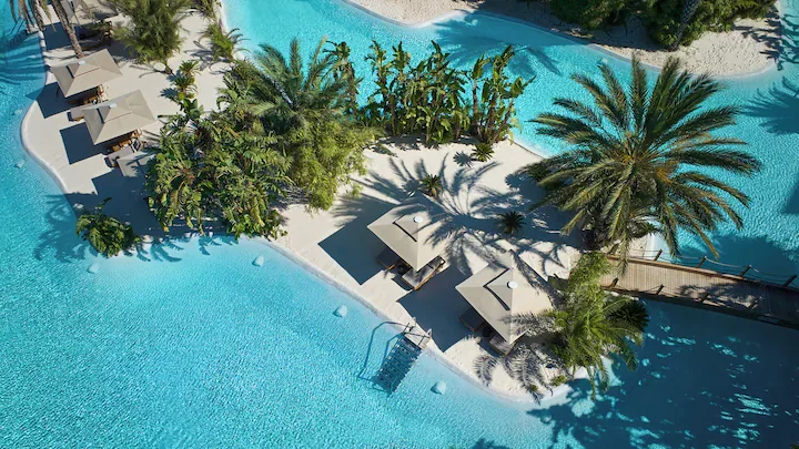 Maxx Royal Belek Golf Resort — lagoon pool with sandy islands and palm shade