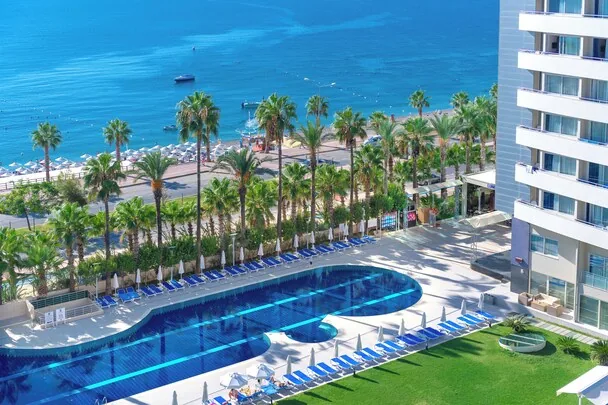 Porto Bello Hotel Resort & Spa — pool deck and palm line facing Konyaaltı beach