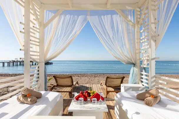 Sherwood Exclusive Lara — beach cabana with daybeds looking out to the Mediterranean