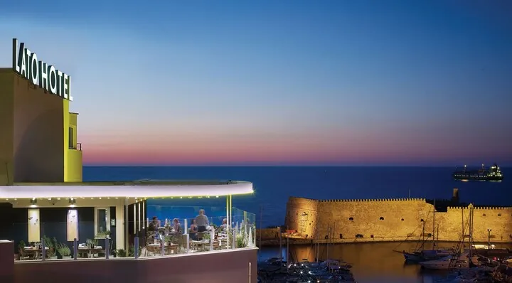 Lato Boutique Hotel — rooftop terrace overlooking Heraklion harbour at dusk