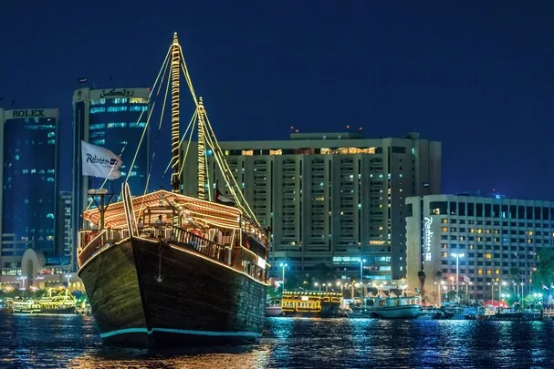 Radisson Blu Hotel Dubai Deira Creek — lit dhow on the creek at night