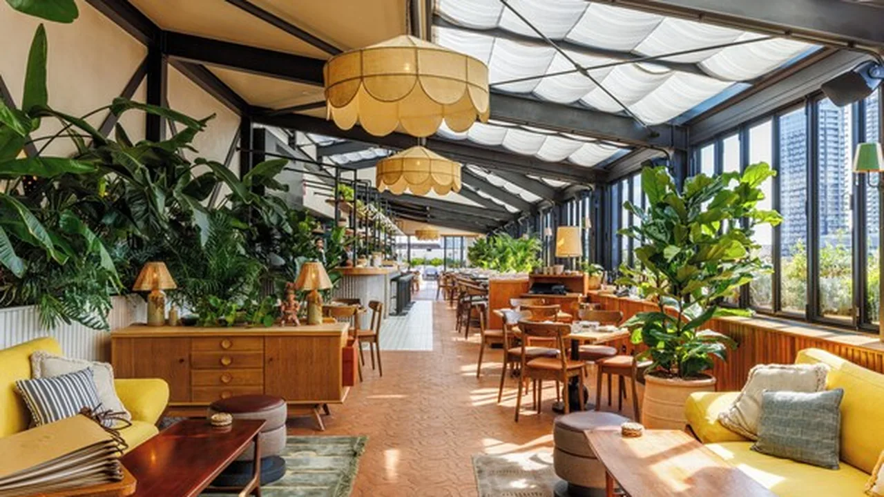 The Hoxton Shoreditch — rooftop lounge with yellow sofas and city views