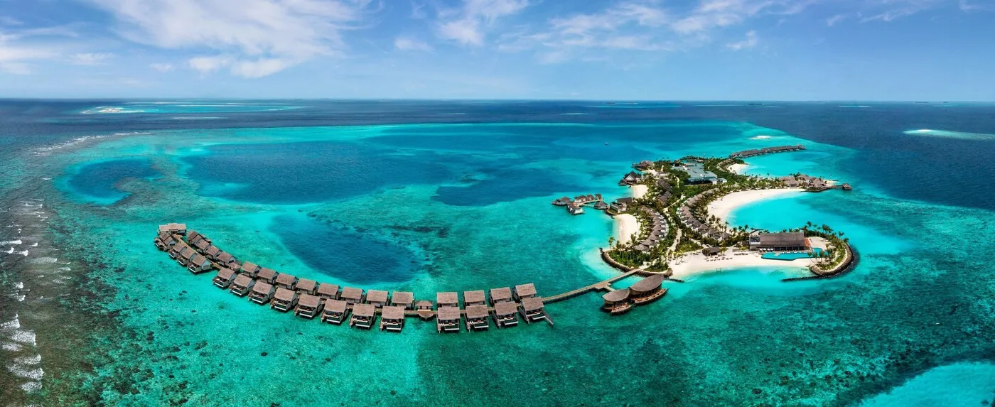 Hilton Maldives Amingiri — overwater villas above turquoise lagoon
