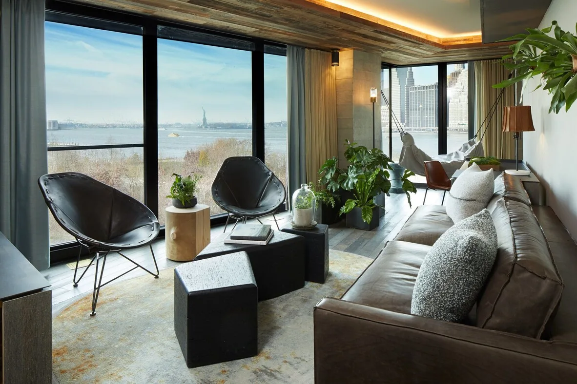 1 Hotel Brooklyn Bridge — lobby with Manhattan skyline through floor-to-ceiling windows