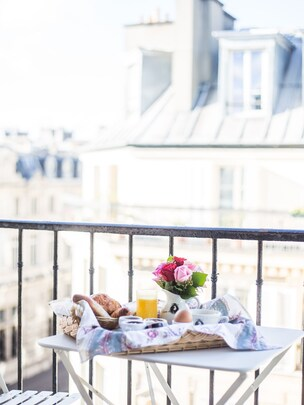 Hôtel Louis II — Parisian balcony breakfast overlooking rooftops near Luxembourg Gardens