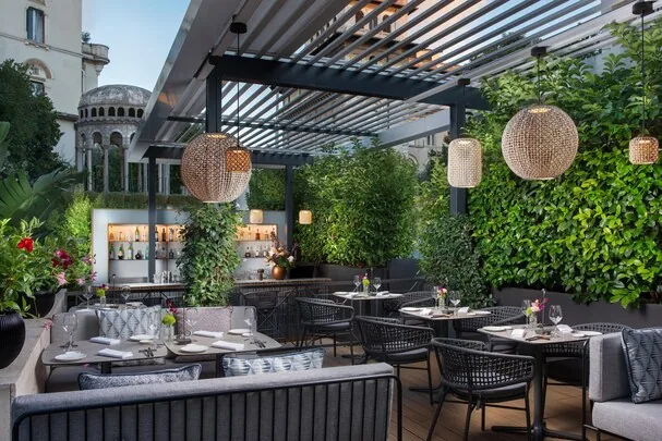 NH Collection Roma Centro — rooftop terrace bar at dusk, Pantheon area Rome