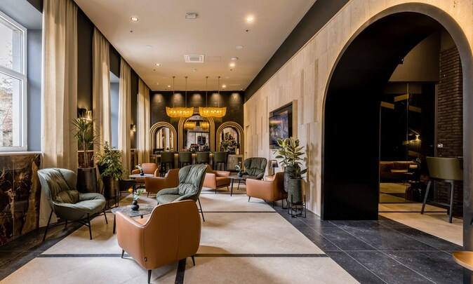 Cornaro Hotel Split — designer lounge with leather armchairs and arched bar