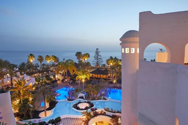 Dreams Jardin Tropical Resort & Spa — lit pools at twilight, Costa Adeje