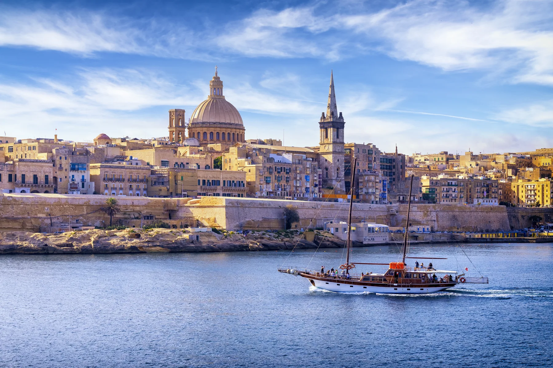 Valletta harbour walls and a sailing boat — Malta