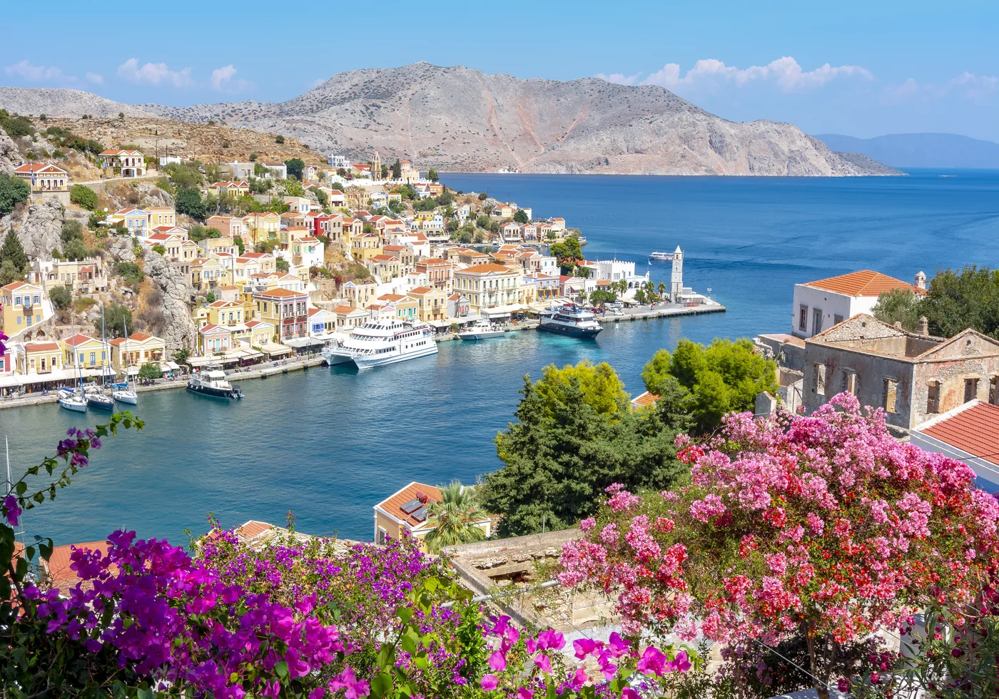 Rhodes harbour town framed by bougainvillea