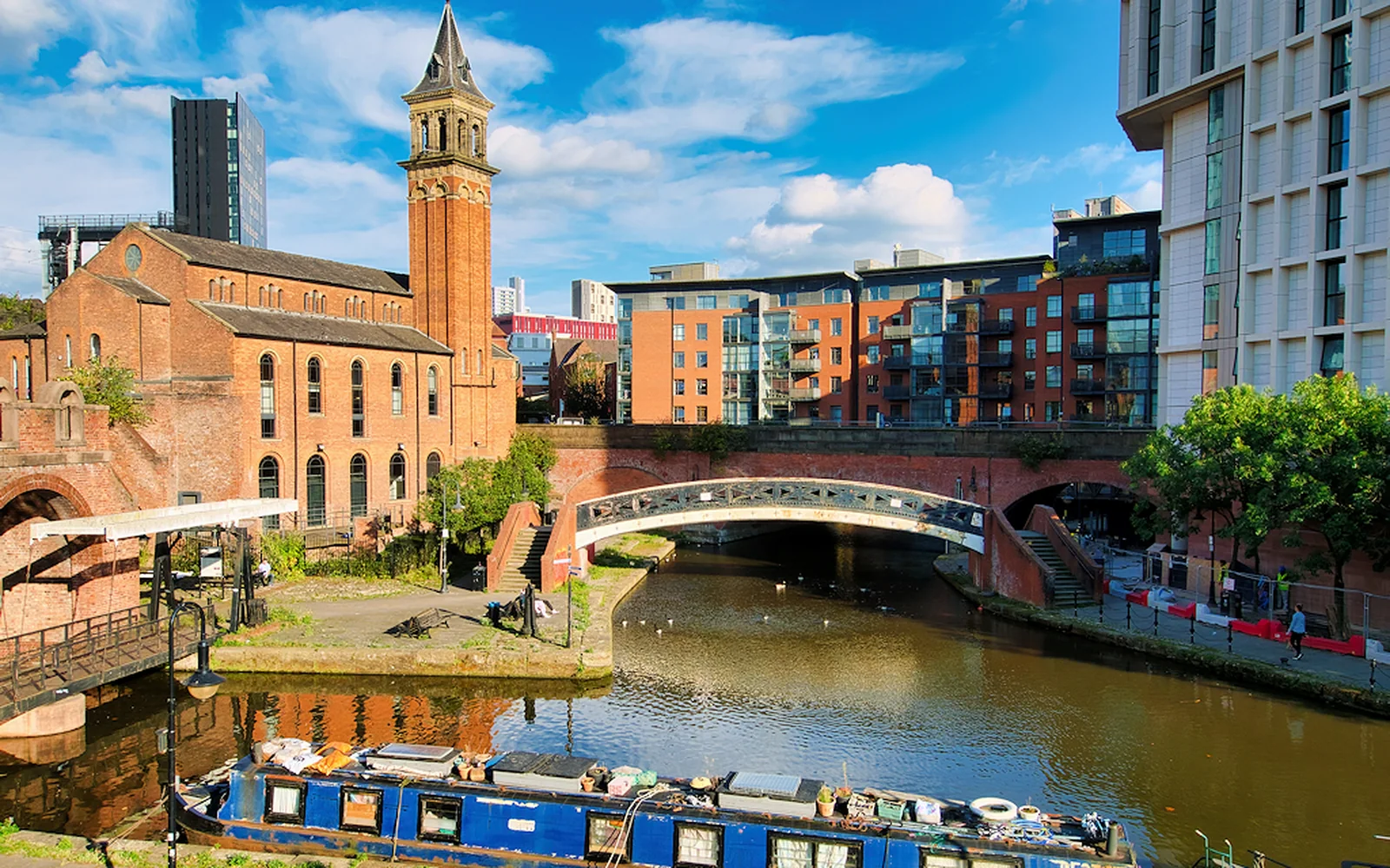 Castlefield canal basin with narrowboat and brick warehouses in Manchester
