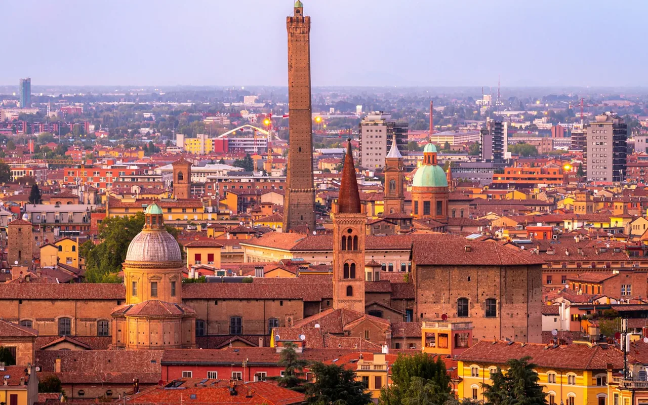 Sunset rooftops and towers across Bologna, Italy